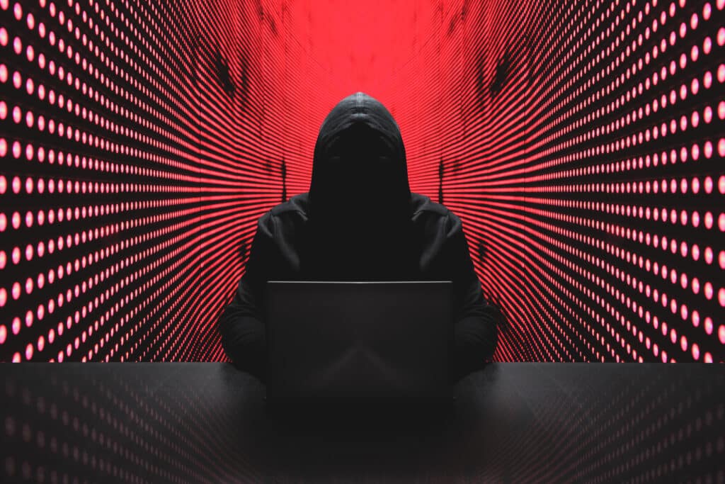 Anonymous hacker in front of his computer