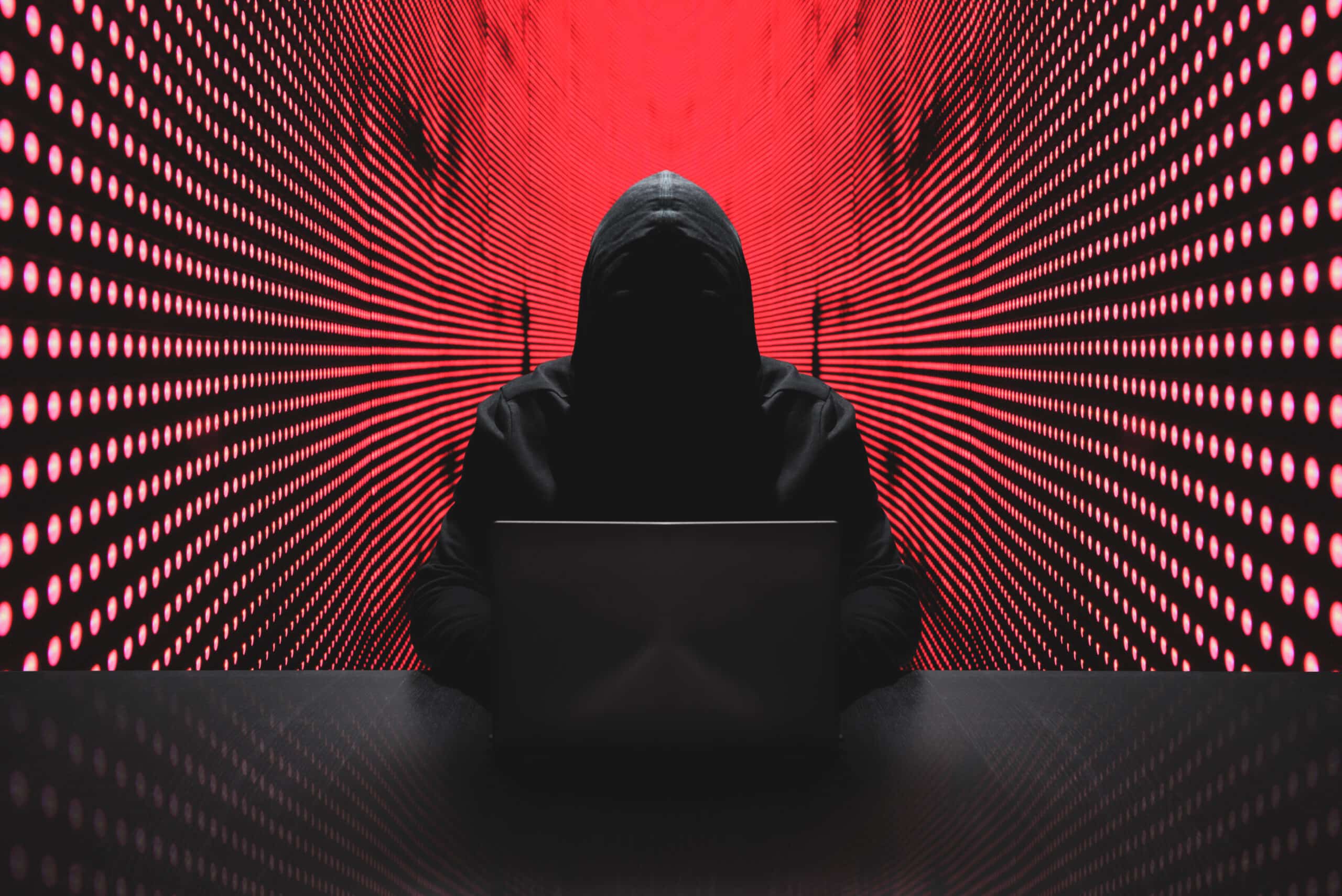Anonymous hacker in front of his computer